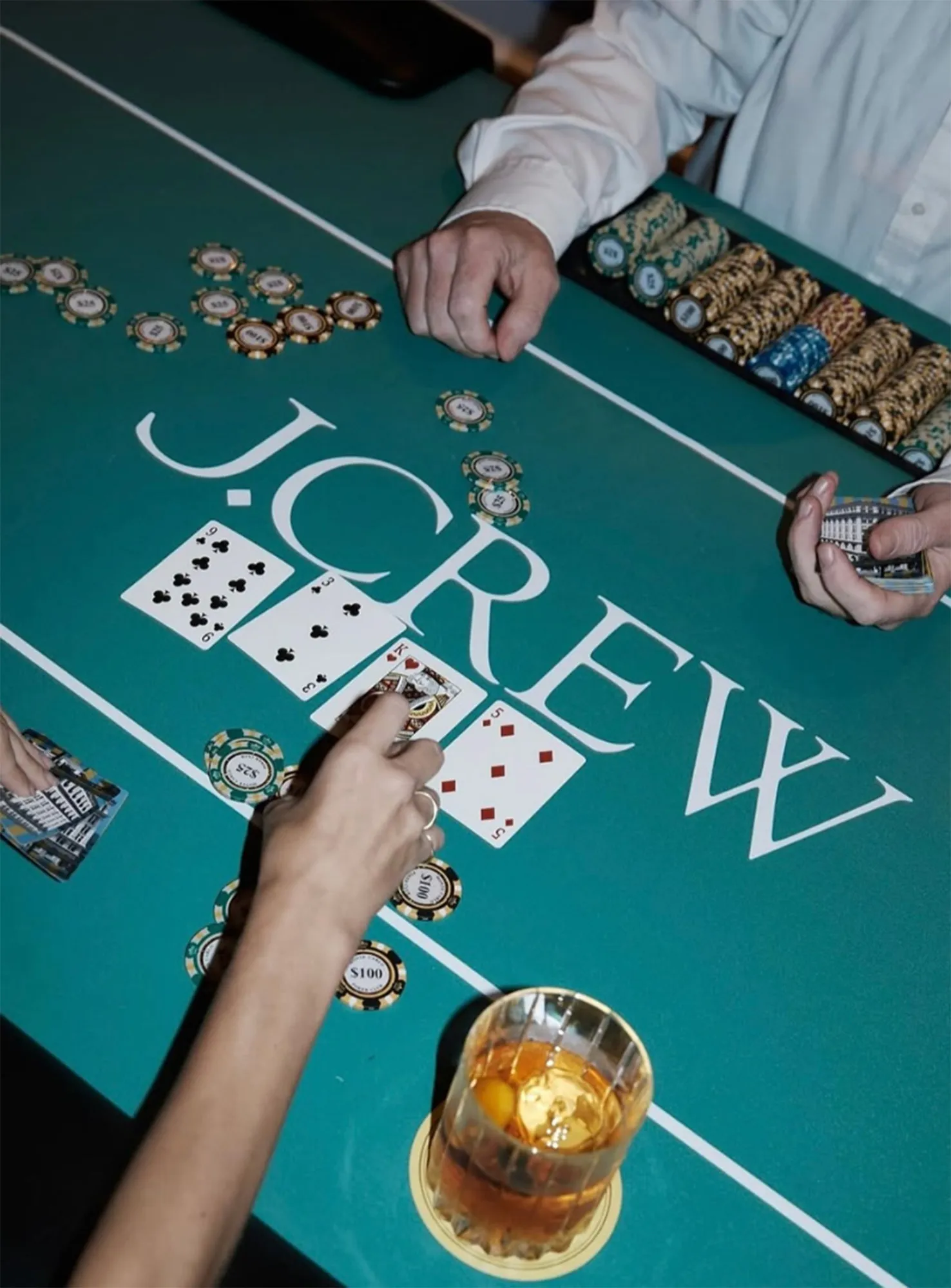 Poker table with 4 cards spread in front of player as dealer deals
