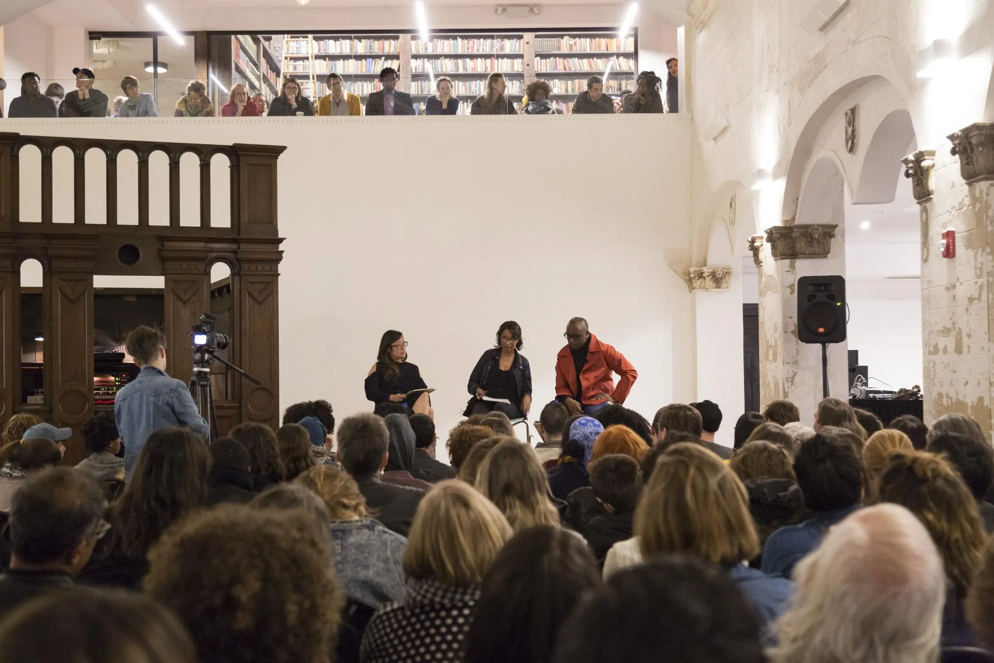 Panelists on stage as people watch