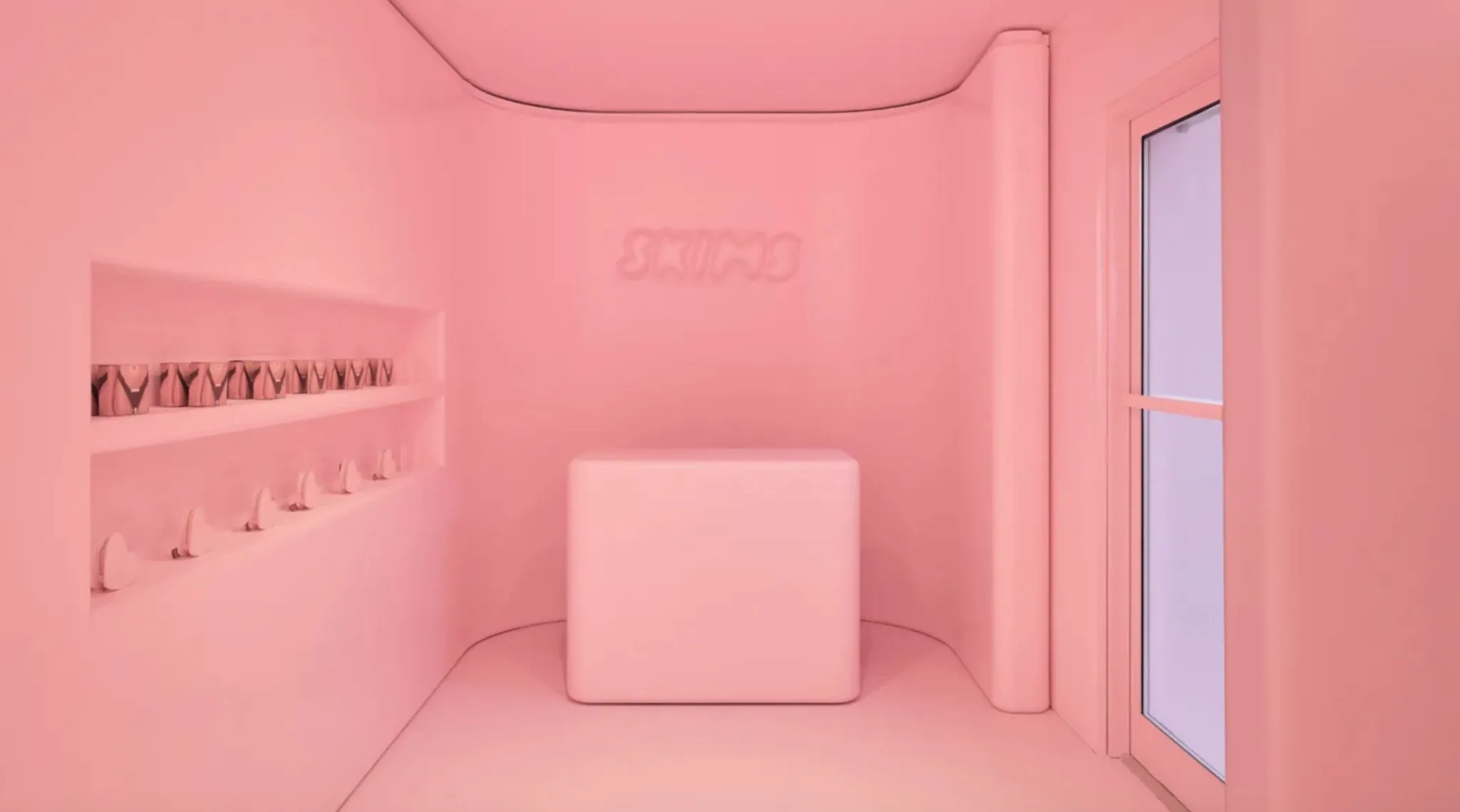 Interior of SKIM's pink, pop up store with shelf and counter.