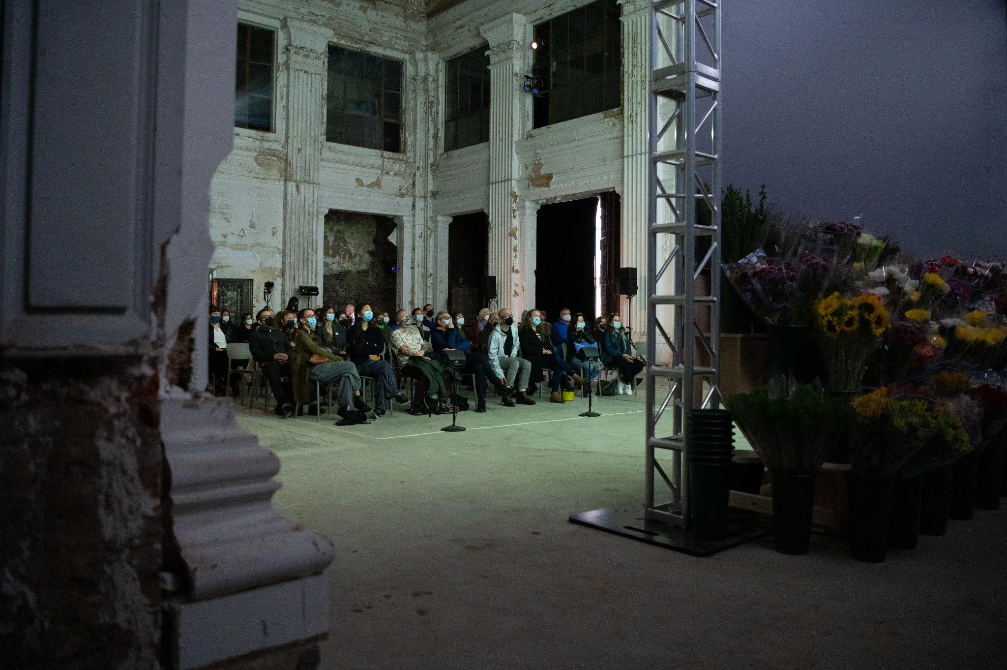 People sitting in chairs looking at the projection screen