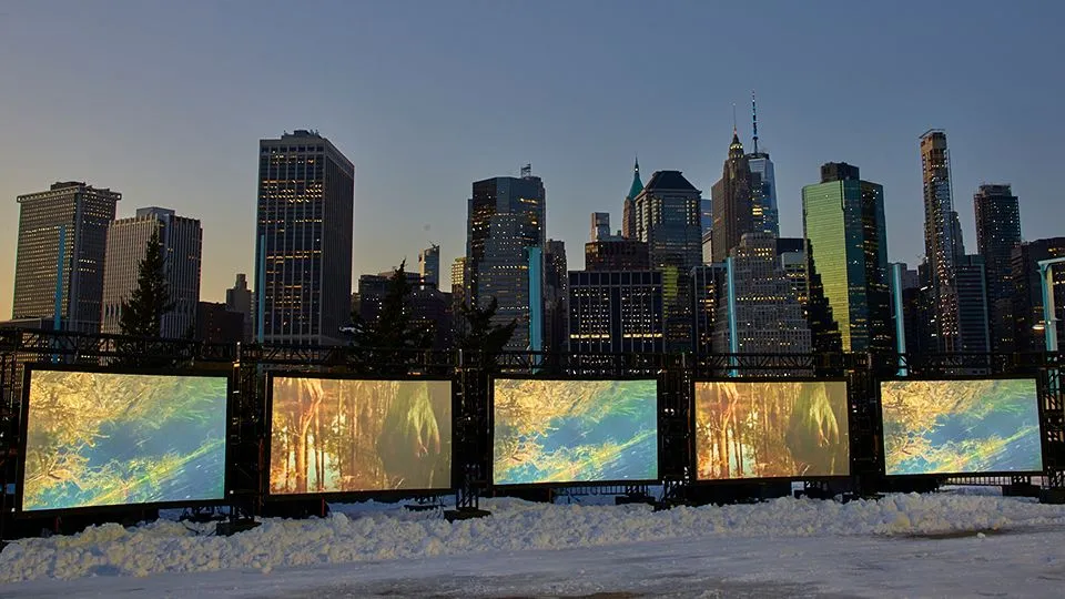 5 projection screens with fractal imagery on them at dusk with the NYC skyline in the background